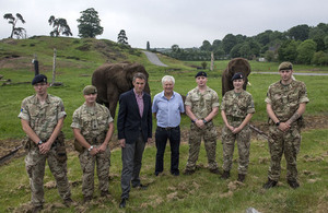 Defence Secretary Gavin Williamson with military personnel standing in front elephants at West Midlands Safari Park