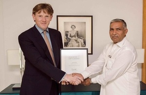 Acting British High Commissioner Richard Crowder presenting the certificate signed by Her Majesty The Queen to Master Ayub.