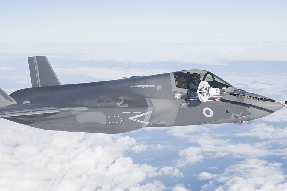 An F-35 jet flying with the clouds. 