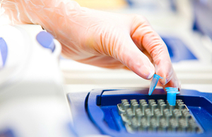 Gloved hand in genome laboratory.