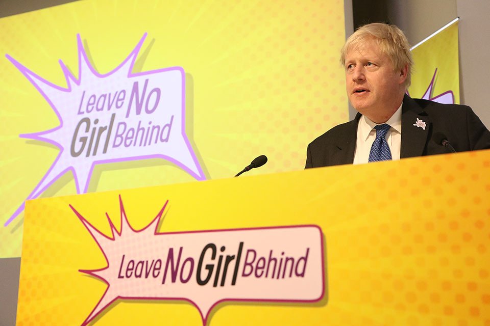 Foreign Secretary speaking with a 'Leave no girl behind' backdrop