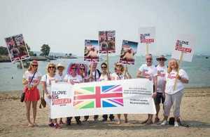 British Consulate staff holding "Love is Great" signs and banner at Vancouver Pride Parade 2017