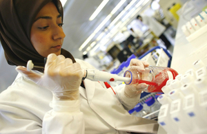 Scientist using pipette in laboratory