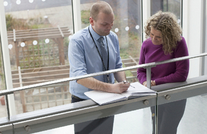 Image: man and woman reading document