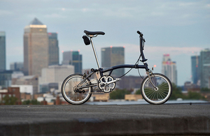 Brompton bike with city skyline in background