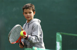 boy playing tennis