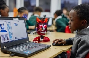 Image of school child learning to code using the Ohbot robot technology.