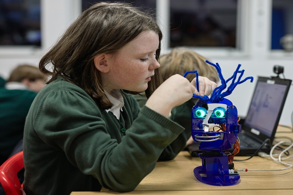 Image of child using the Ohbot robot.