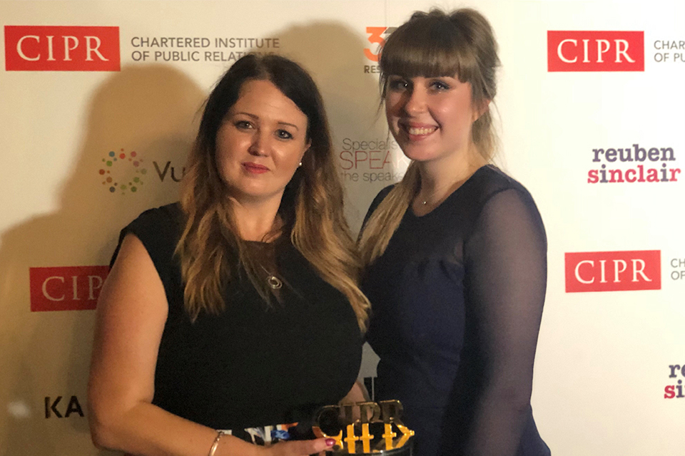 Image of Abigail Britten and Olivia Roe collecting the CIPR Excellence Award