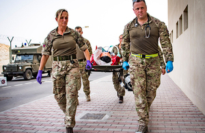 Members of the Joint Medical Group carry a simulated casualty on a stretcher