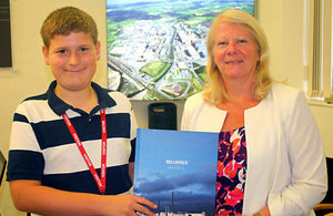 Samuel Boardman being presented with a Sellafield Ltd picture book by Dorothy Gradden