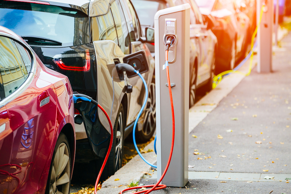 Electric vehicles charge in city centre.