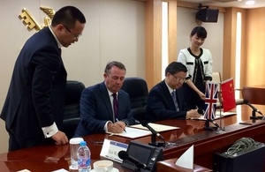 International Trade Secretary signing UK-China Dairy Agreement