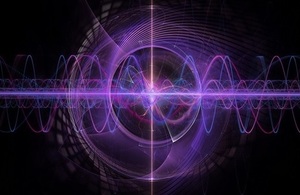 Purple spotlight with waving lines crossing across a black background