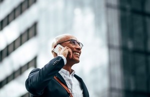 Businessman on a mobile phone via Joseph Lund at Shutterstock