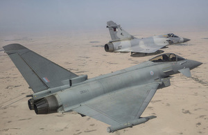 RAF Typhoon (foreground) and a QEAF Mirage jet taking part in a joint exercise held by the Emir of Qatar's Air Force.
