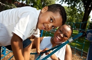 A mother and son play in a playground