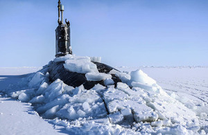 Royal Navy submarine HMS Trenchant breaks through the ice at the Arctic.