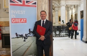 Picture of the International Trade Secretary at Downing Street in front of an Invest in GREAT campaign banner.