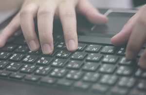 Hands typing on a keyboard