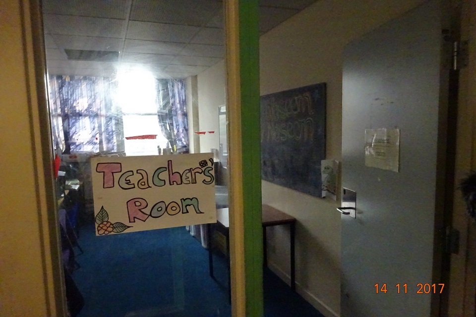 Unregistered school room with handmade sign on the door saying 'teachers' room'