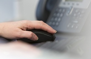 Female hand clicking on a mouse