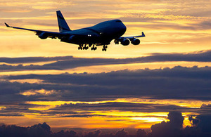 Picture of a commercial passenger plane at sunset.