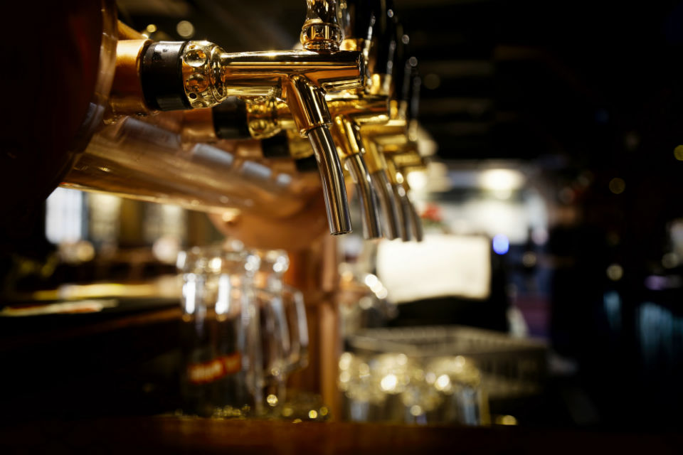 A picture of beer taps on a bar.