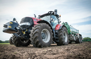 A tractor and liquid manure spreader in a field