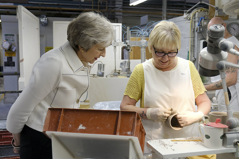 Prime Minister Theresa May speaking to worker in pottery factory