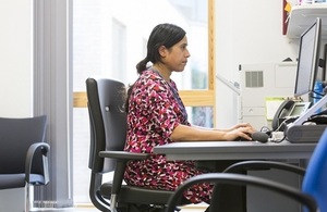 Side view of a doctor working at her desk.