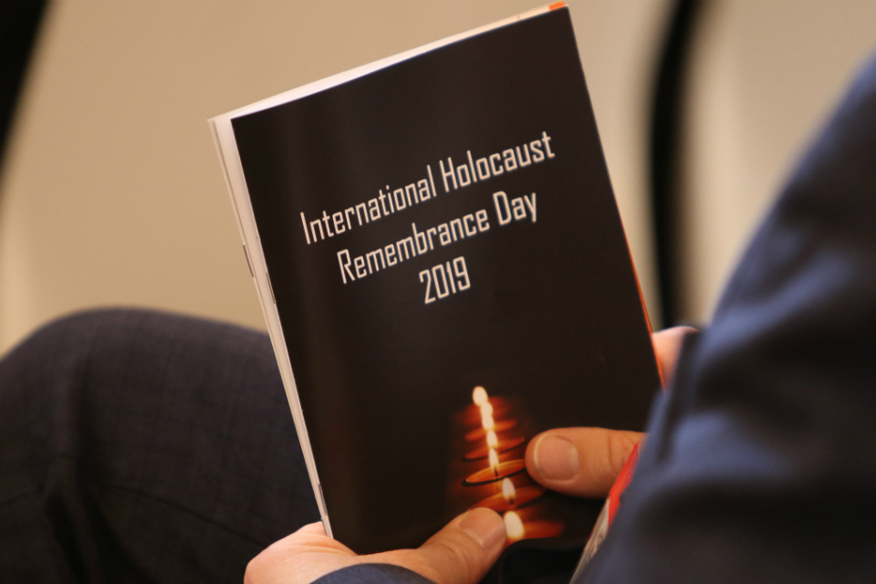 International Holocaust Remembrance Day 2019 event, person holding a book