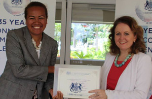 Dr Lusiana Manoa receives her certificate from High Commissioner Melanie Hopkins