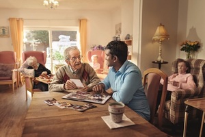 Carer talking to gentleman in care home