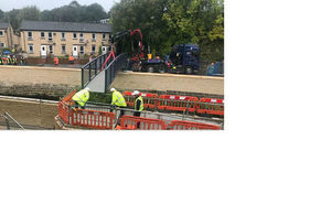 Construction workers replace footbridge at Cragg Brook