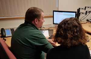 Image of RAIB staff reviewing information on a computer screen