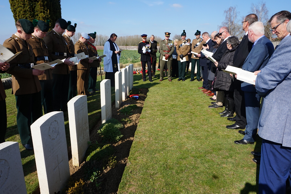 Members of The Royal Irish Regiment and the family of Captain Harvey look on during the rededication service at Noyon New British Cemetery. MOD Crown Copyright.