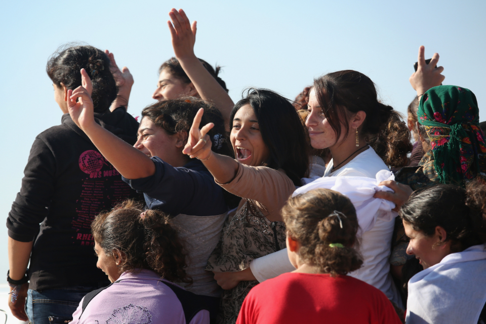 Yazidi refugees celebrate news of the liberation of their homeland of Sinjar from ISIL extremists, while at a refugee camp on November 13, 2015