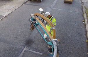 Picture of worker filling a pothole.