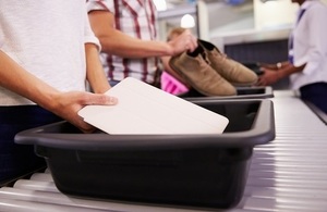 Image of passengers using airport trays