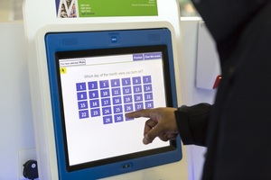 Man using an interactive screen at a medical centre