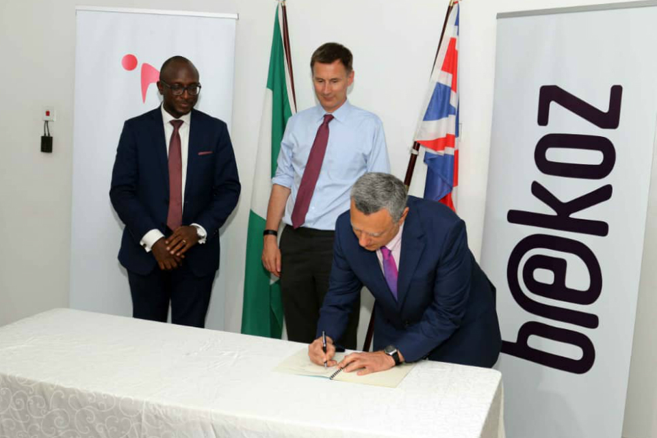 Jeremy Hunt watches representatives of UK company Bekoz and Nigerial company Interswitch GRP sign a £56 million deal.