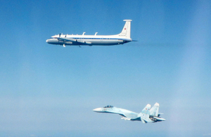 A Russian SU-27 flanker aircraft and a Russian IL-22 aircraft
