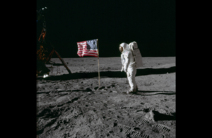 Astronaut on the moon next to the American flag
