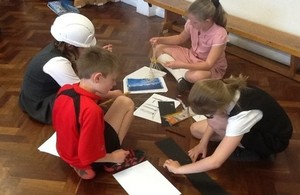 School children learning how to build a bridge