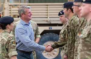 Defence Minister Stuart Andrew meeting service personnel at Jellalabad barracks in front of a Mastiff armoured vehicle