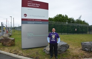 John Maxwell standing in front of the LLWR totem