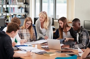 Academy students around desk