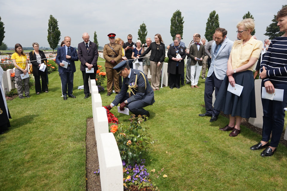 Group Capt Justin Fowler, Defence Attache Belgium and Luxembourg, lays a wreath at Capt Kington's grave in Tyne Cot Cemetery, Crown Copyright, All rights reserved