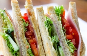 A picture of several sandwiches with lettuce, tomato and meat.